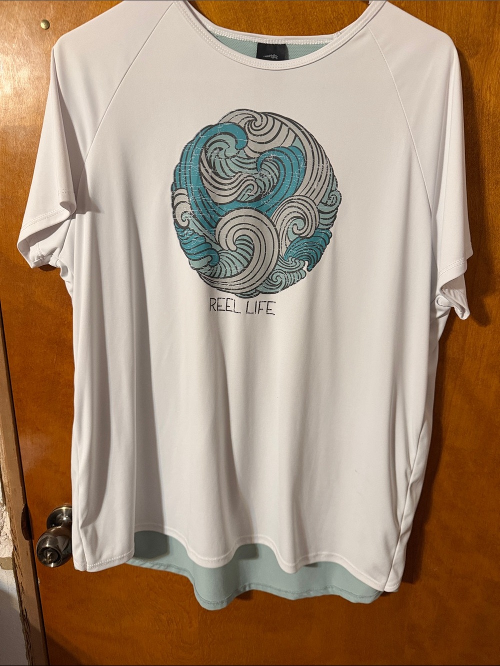Reel Life Women’s White Short-Sleeve Graphic Tee with Teal Wave Design